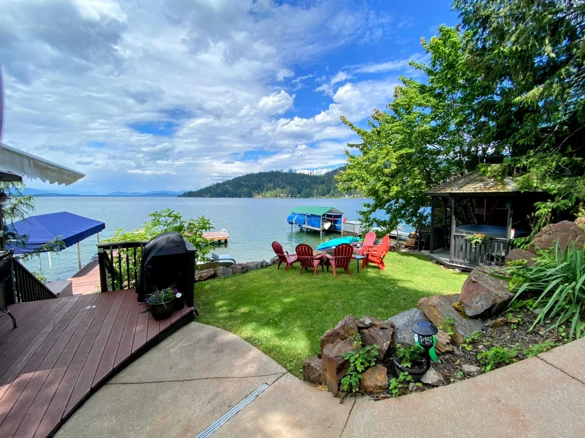 Lakefront yard at Bottle Bay cabin with private dock and gazebo on Lake Pend Oreille