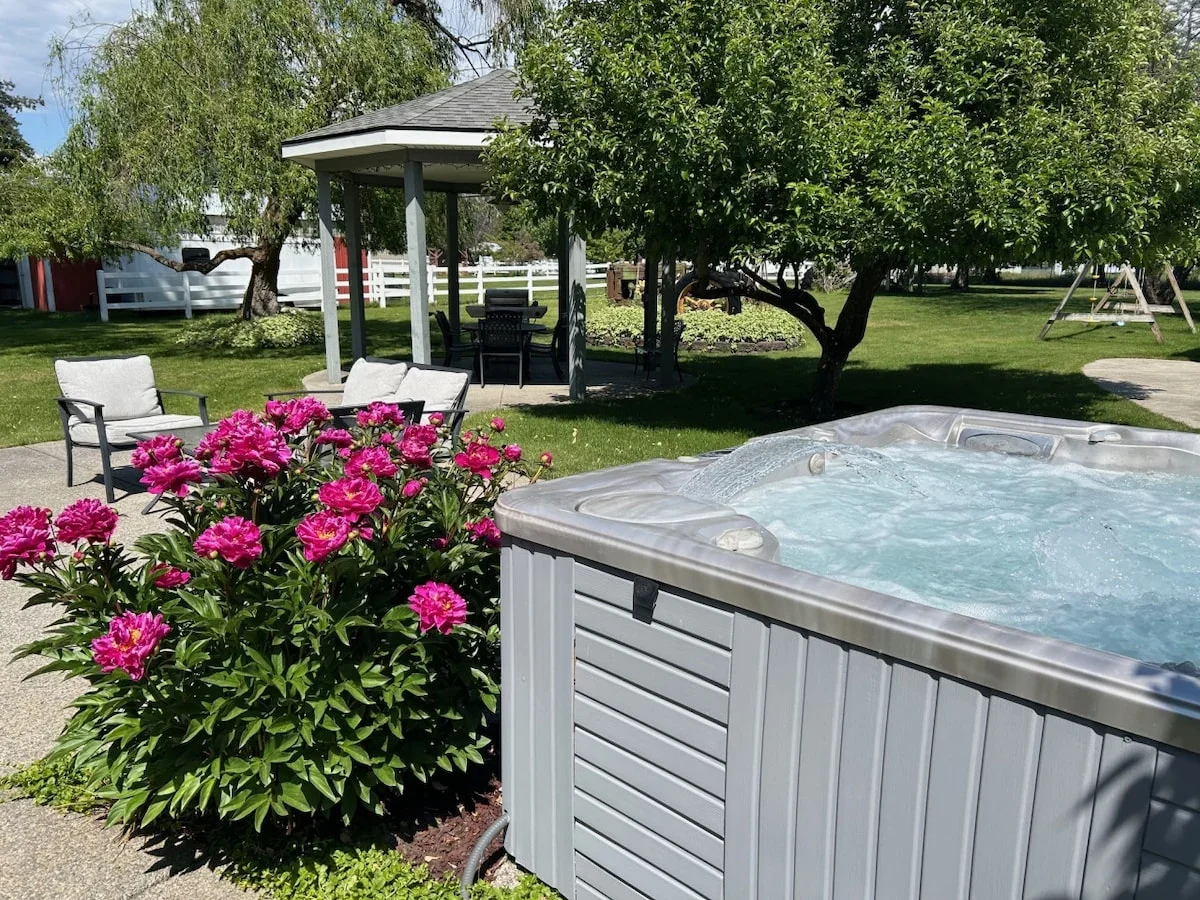 Private hot tub with gazebo and lawn at Farmhouse Retreat in Dalton Gardens.