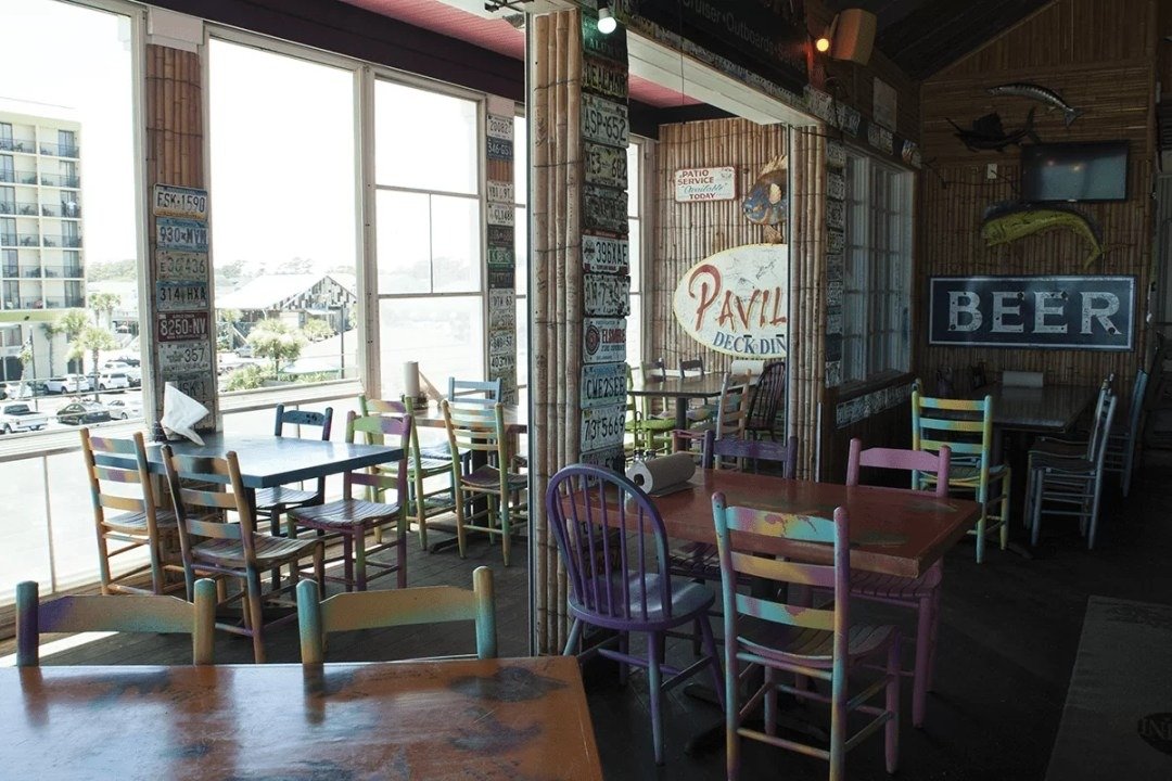 Colorful painted chairs inside a casual beach bar