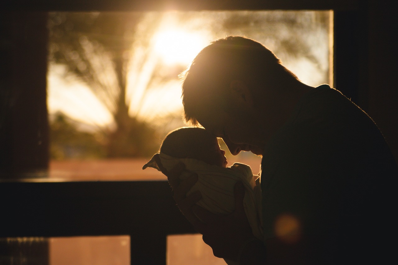 Silhouette of a dad holding a baby, Father's Day in Austin.