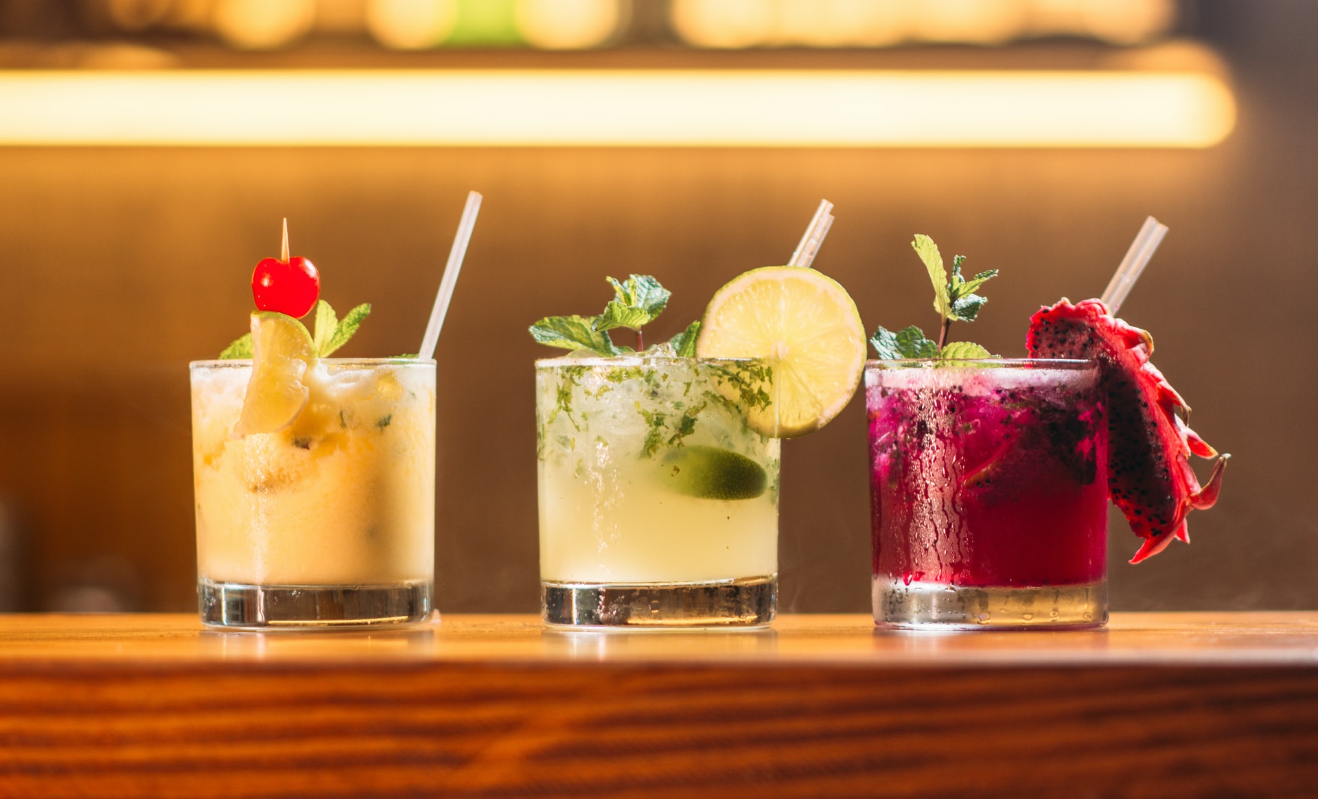three cocktails on a bar top