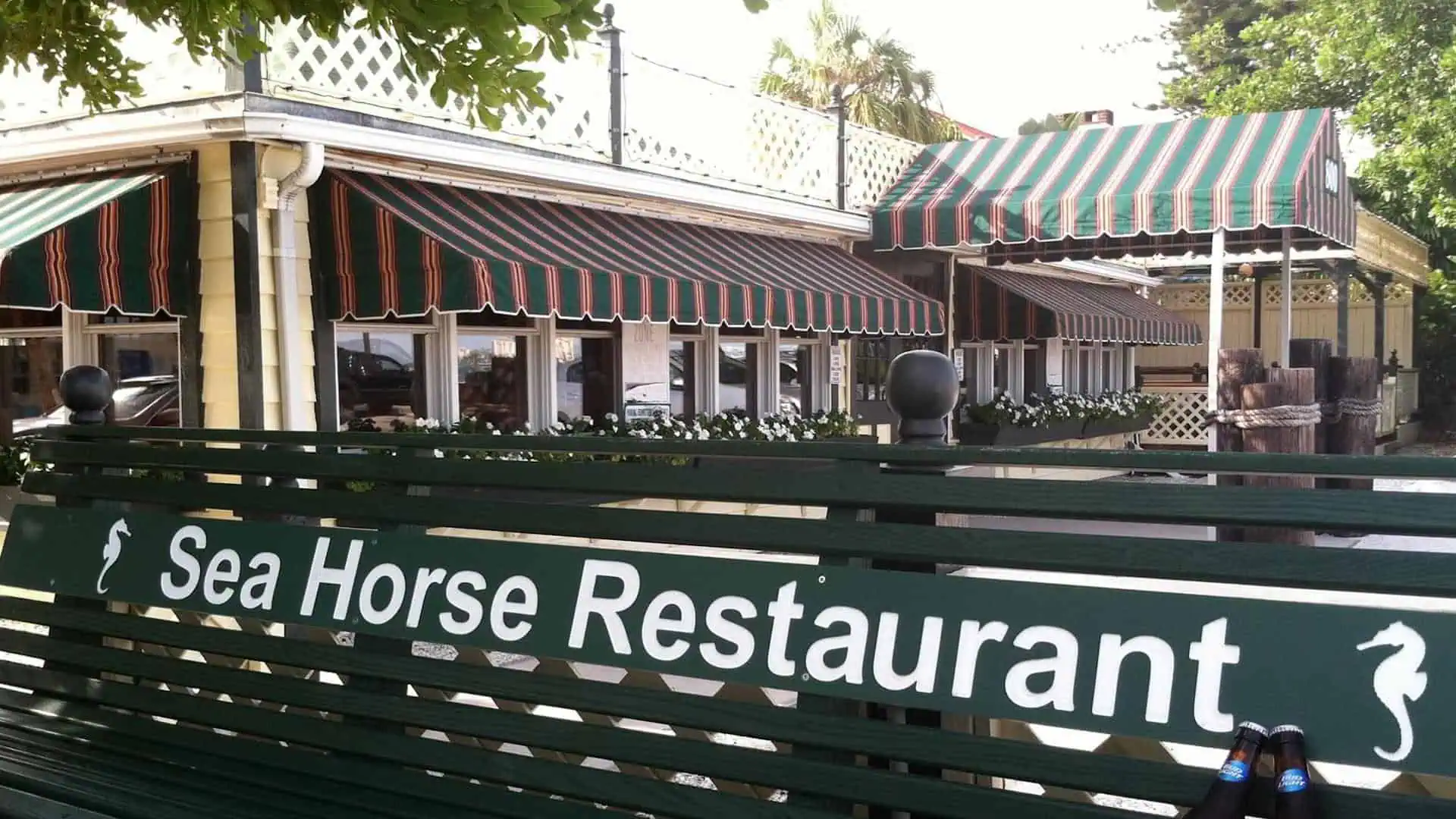 outside a breakfast restaurant with green benches