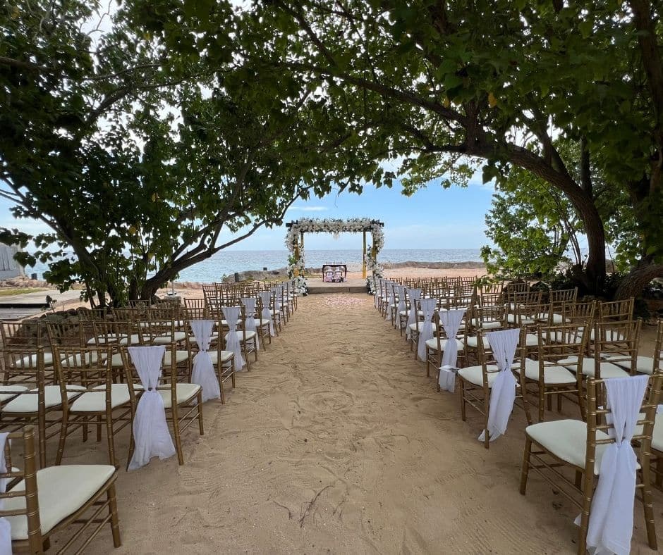 Ceremony set up at Borghinvilla Jamaica wedding venue walking distance from Mais Oui Villa in Discovery Bay Jamaica for a Jamaica villa wedding with a large guest list
