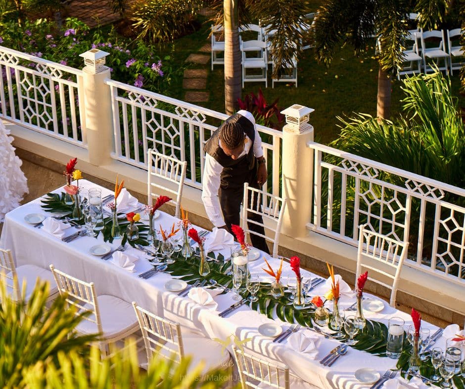 butler setting up at a wedding reception at a villa vs resort wedding