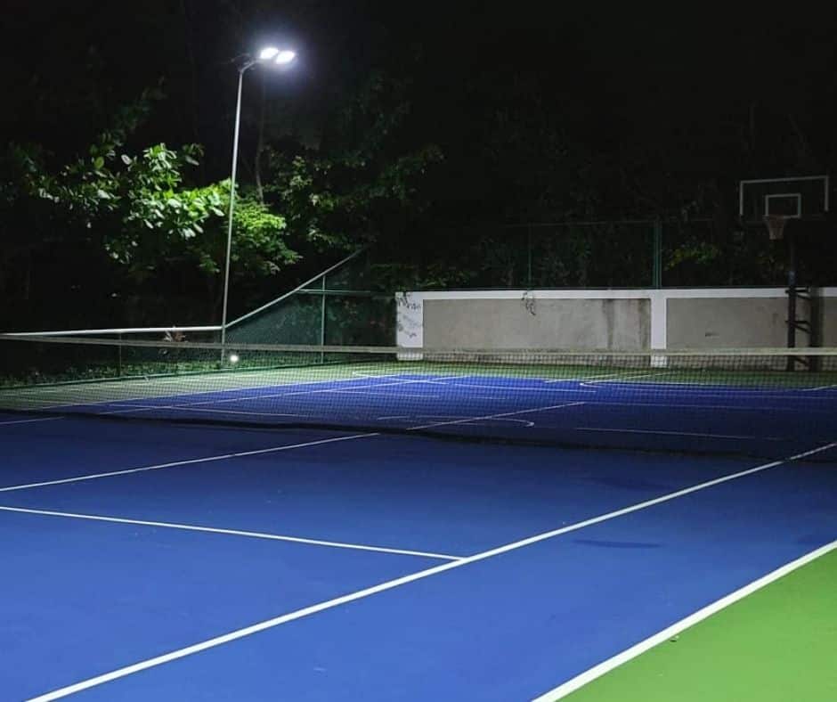 Night lit multipurpose court at Mais Oui Villa in Discovery Bay Jamaica for pickleball, tennis, and basketball