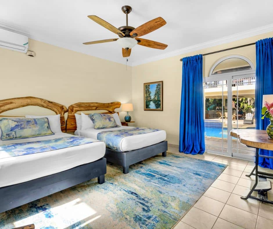Bedroom with two beds at Mais Oui Villa in Discovery Bay Jamaica