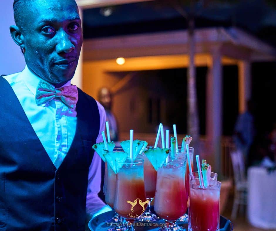 butler serving drinks at a villa vs resort wedding in Jamaica