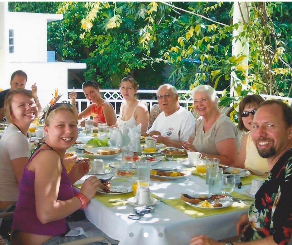 Family eating lunch by the pool during a multigenerational family vacation at Mais Oui Villa in Discovery Bay Jamaica