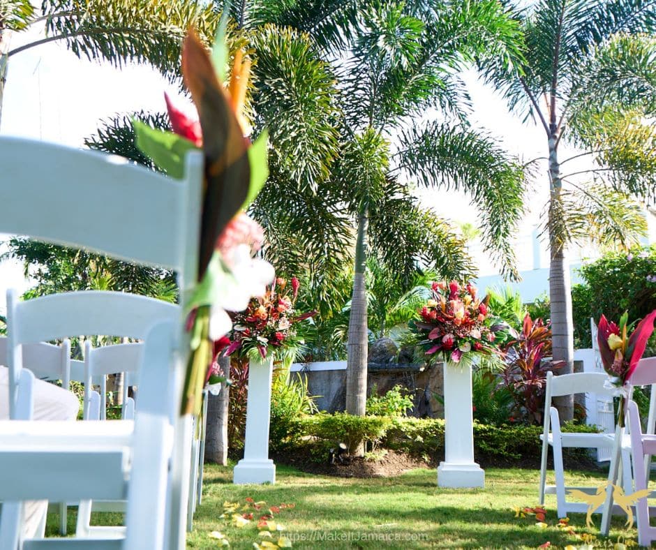 Garden ceremony site for intimate wedding in Jamaica decorated with tropical flowers - planning a wedding in Jamaica