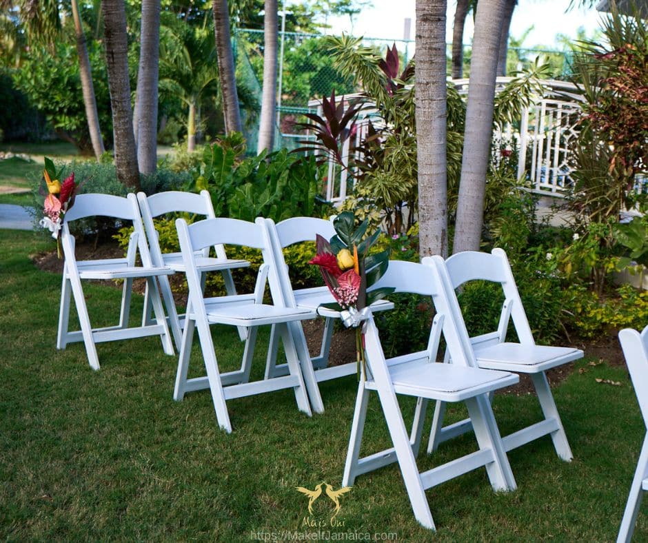 white garden chairs set up for a wedding at Mais Oui Villa a wedding venue in Jamaica