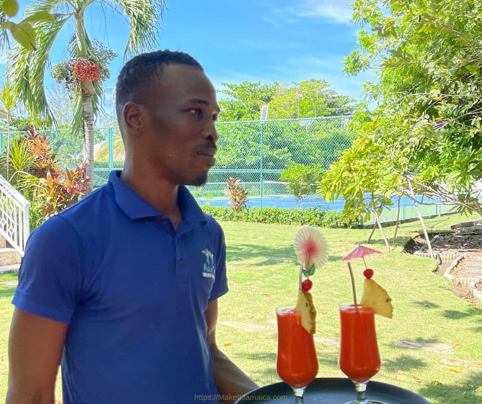 Butler serving drinks in the garden at Mais Oui Jamaica vacation house