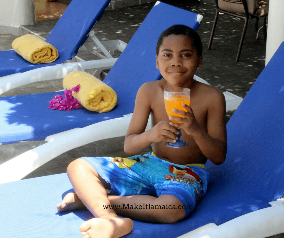 kids sitting by the pool at Mais Oui Villa in Discovery Bay Jamaica