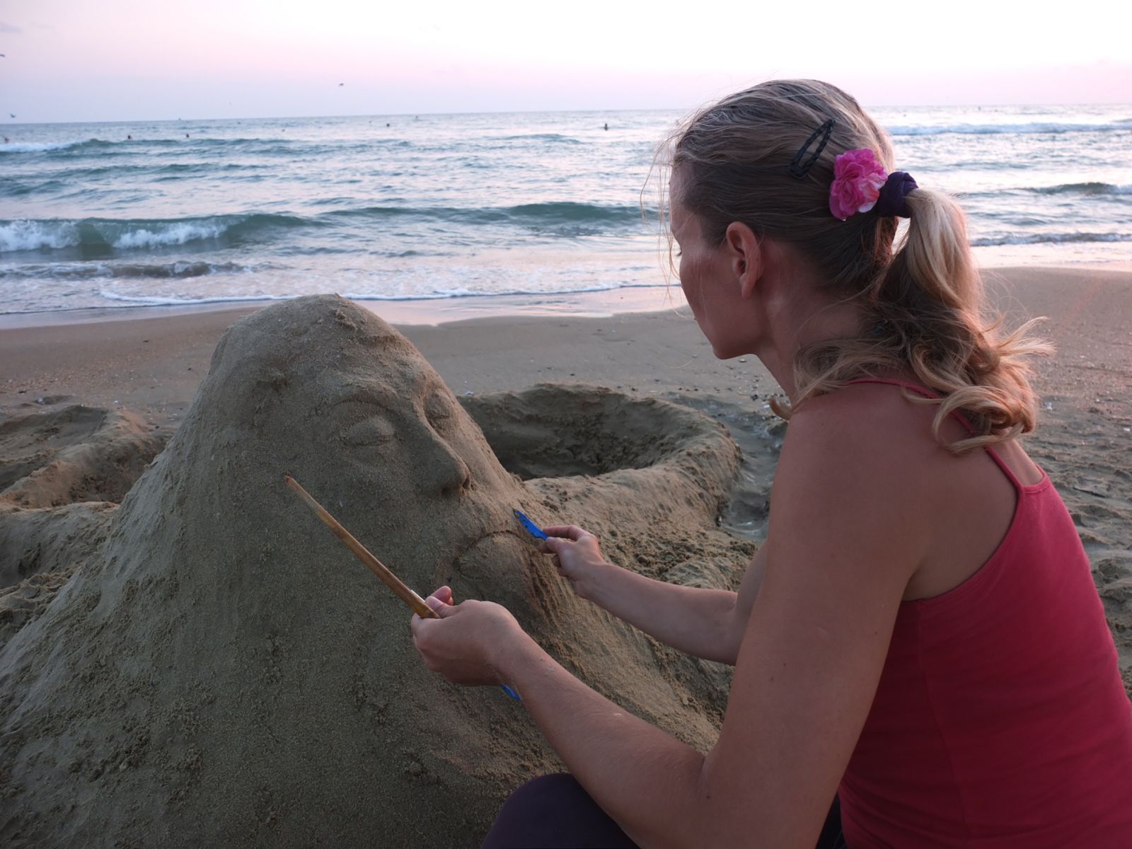woman making sand sculpture