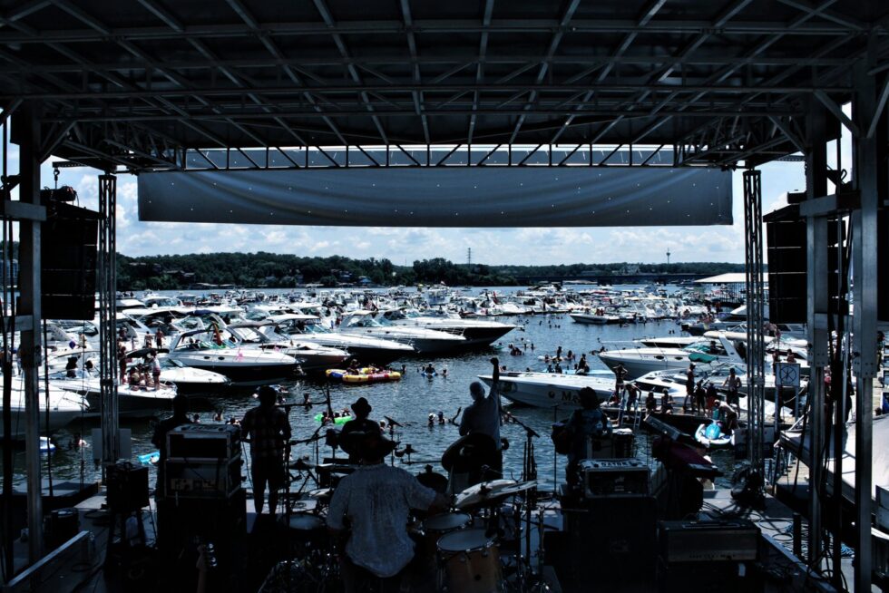 View from behind the stage at Aquapalooza on Lake of the Ozarks, looking out over hundreds of boats rafted together in the cove