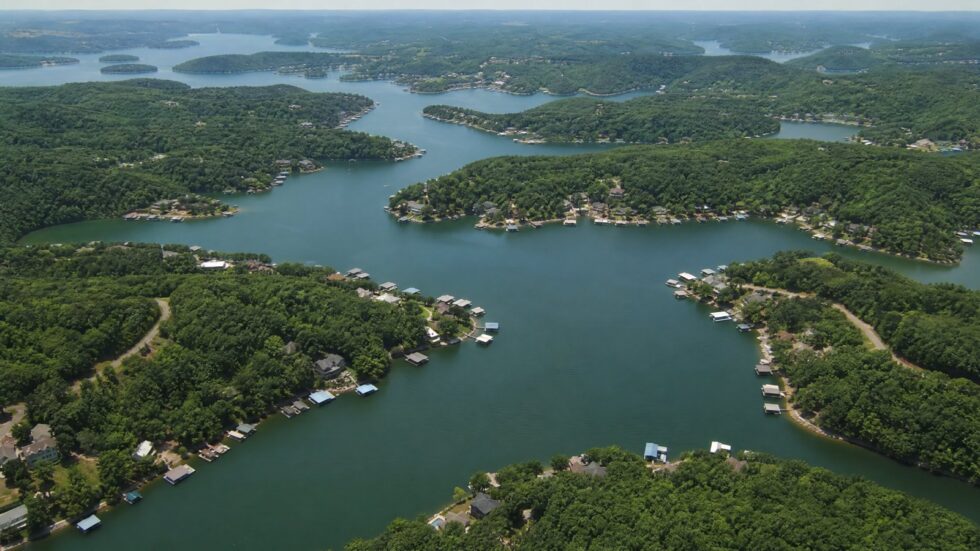 Aerial view of Lake of the Ozarks showing winding wooded coves, boat docks, and the main channel