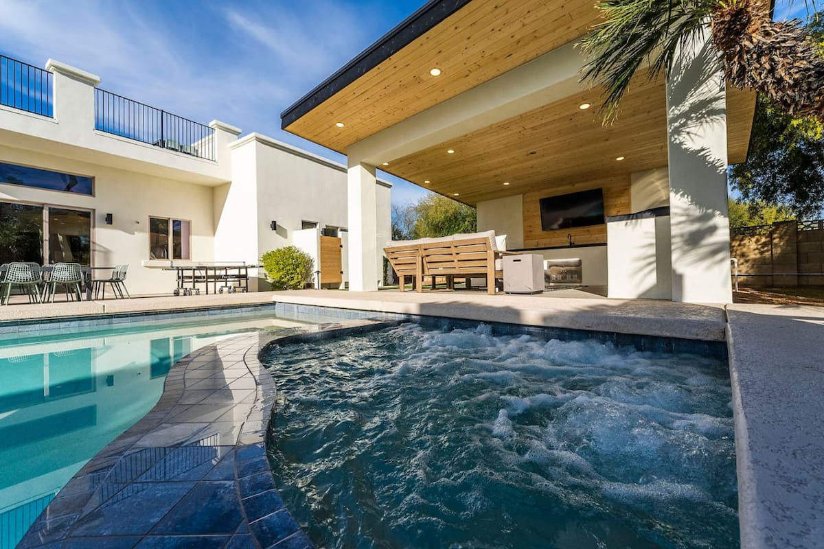 Heated spa and pool beside the covered outdoor living area