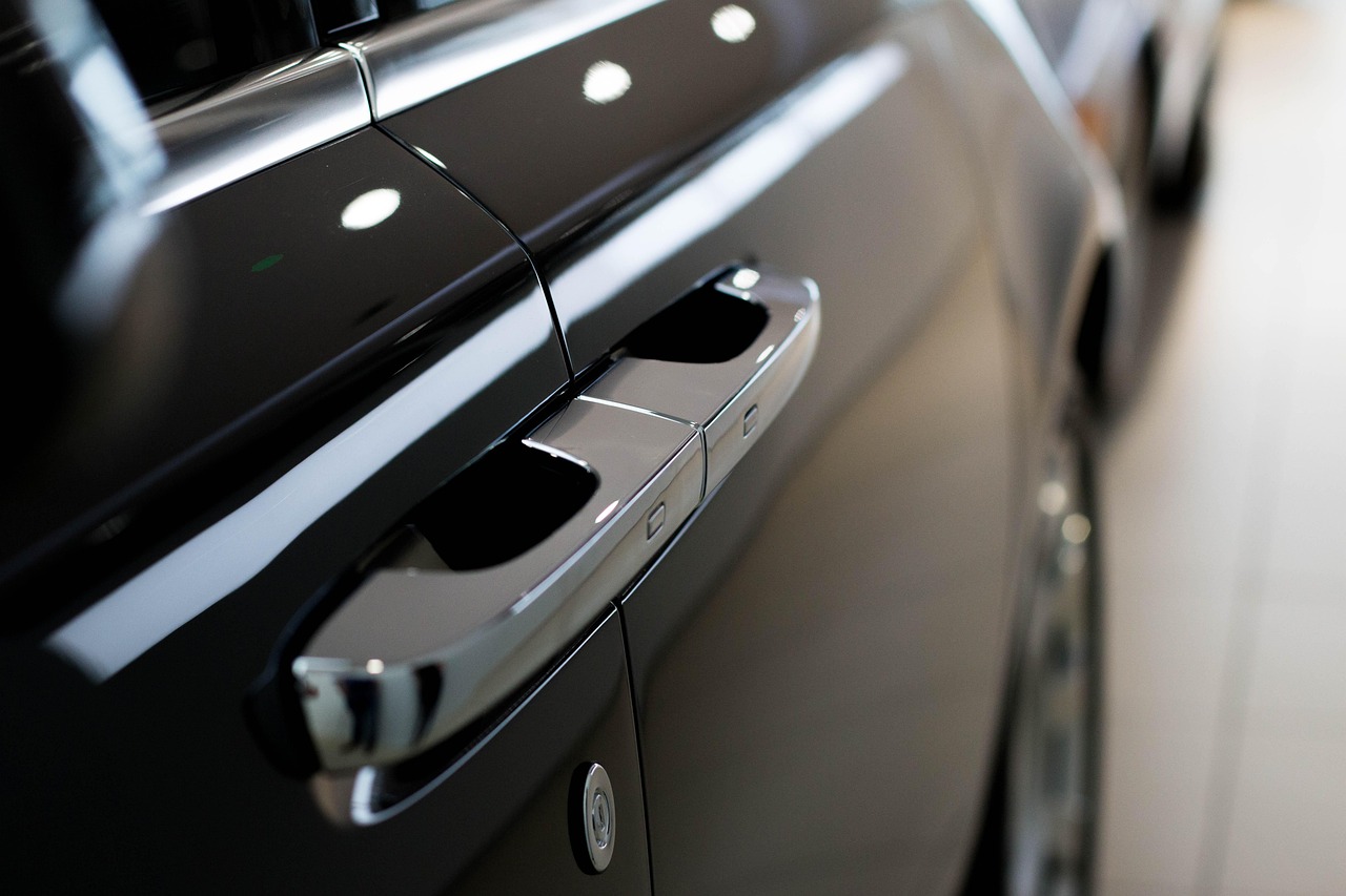 Primer plano de la manija de la puerta de un coche negro de lujo con detalles cromados