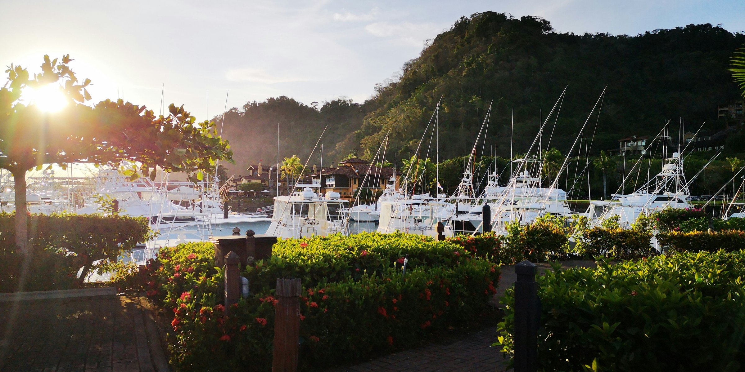 Sportfishing boats moored at Los Sueños Marina in Herradura Bay, Puntarenas, under morning cloud