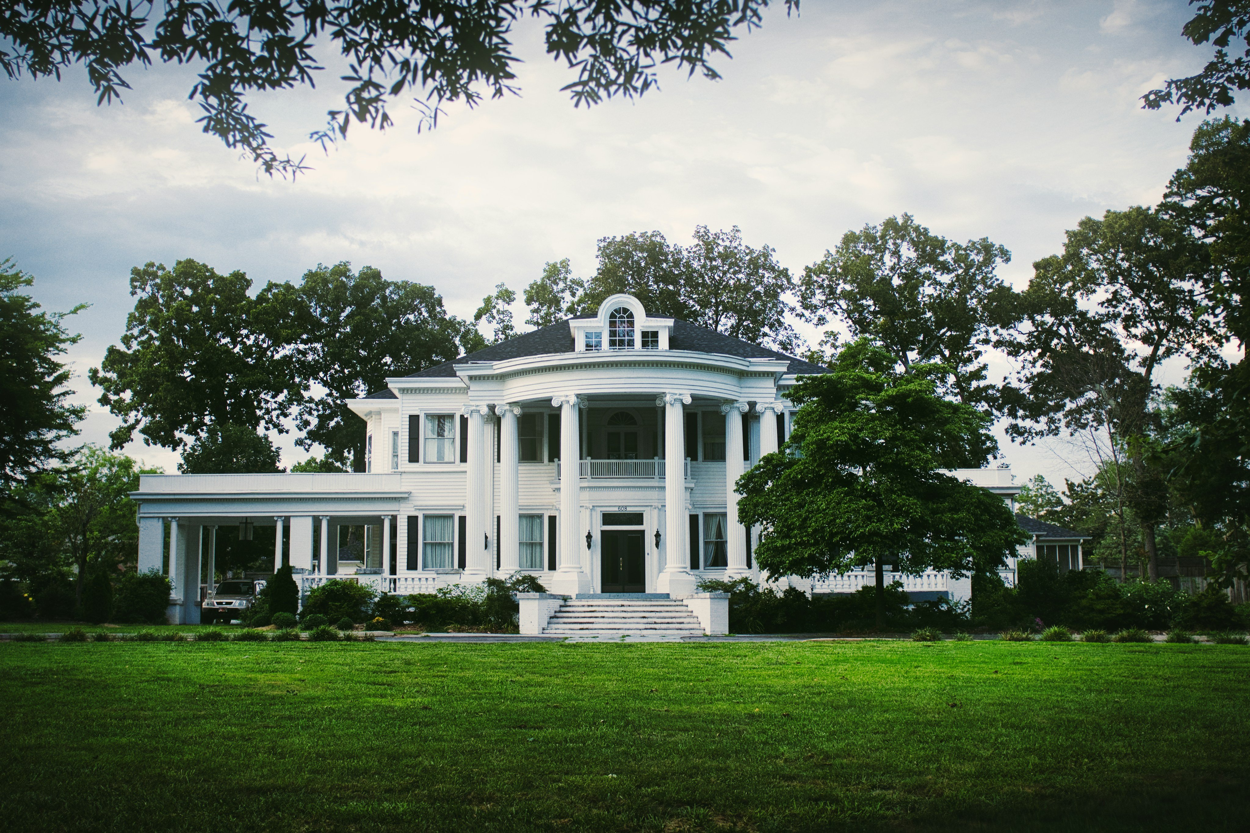 Historic Southern colonial mansion with columns and lawn