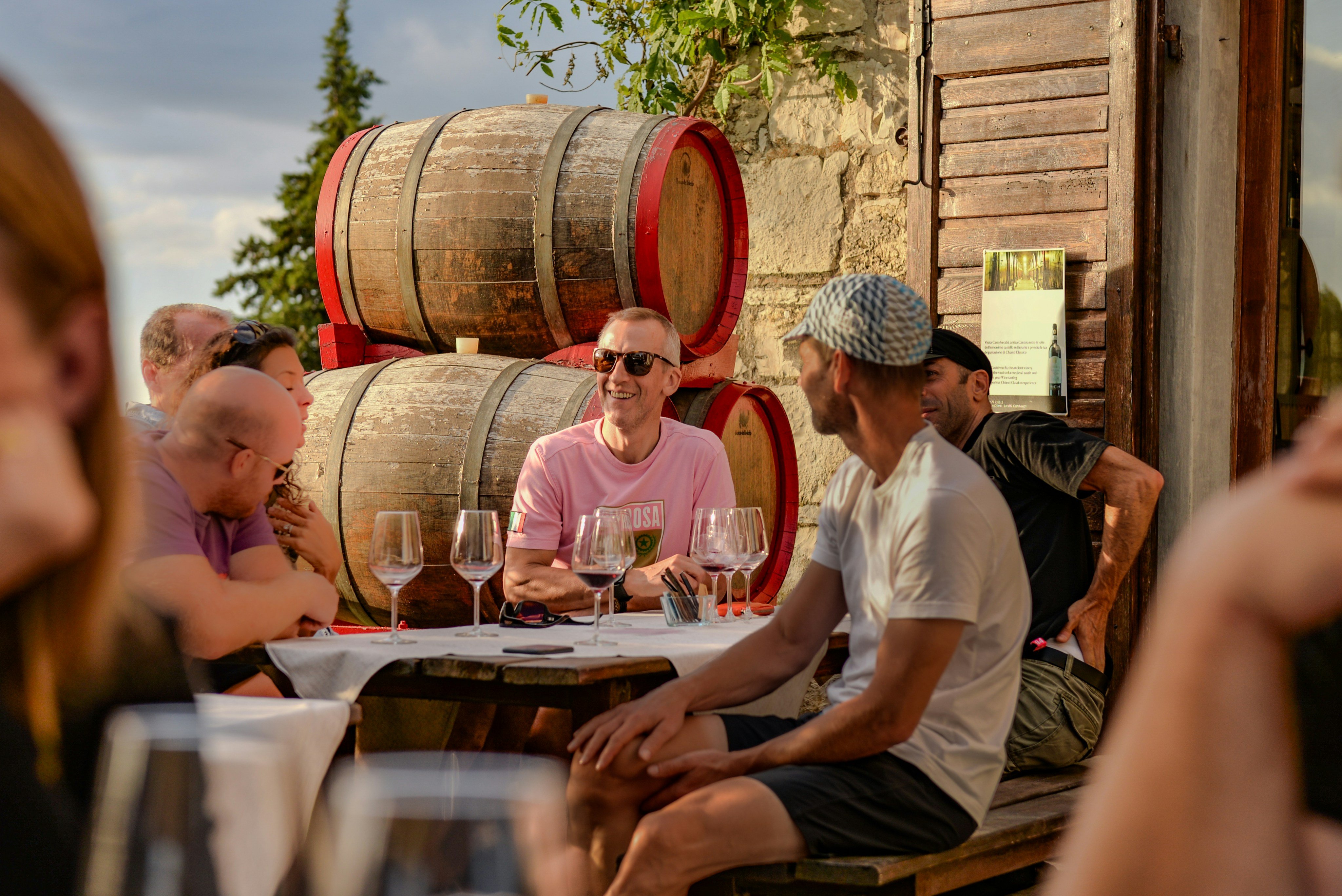 Group wine tasting at a winery with barrels