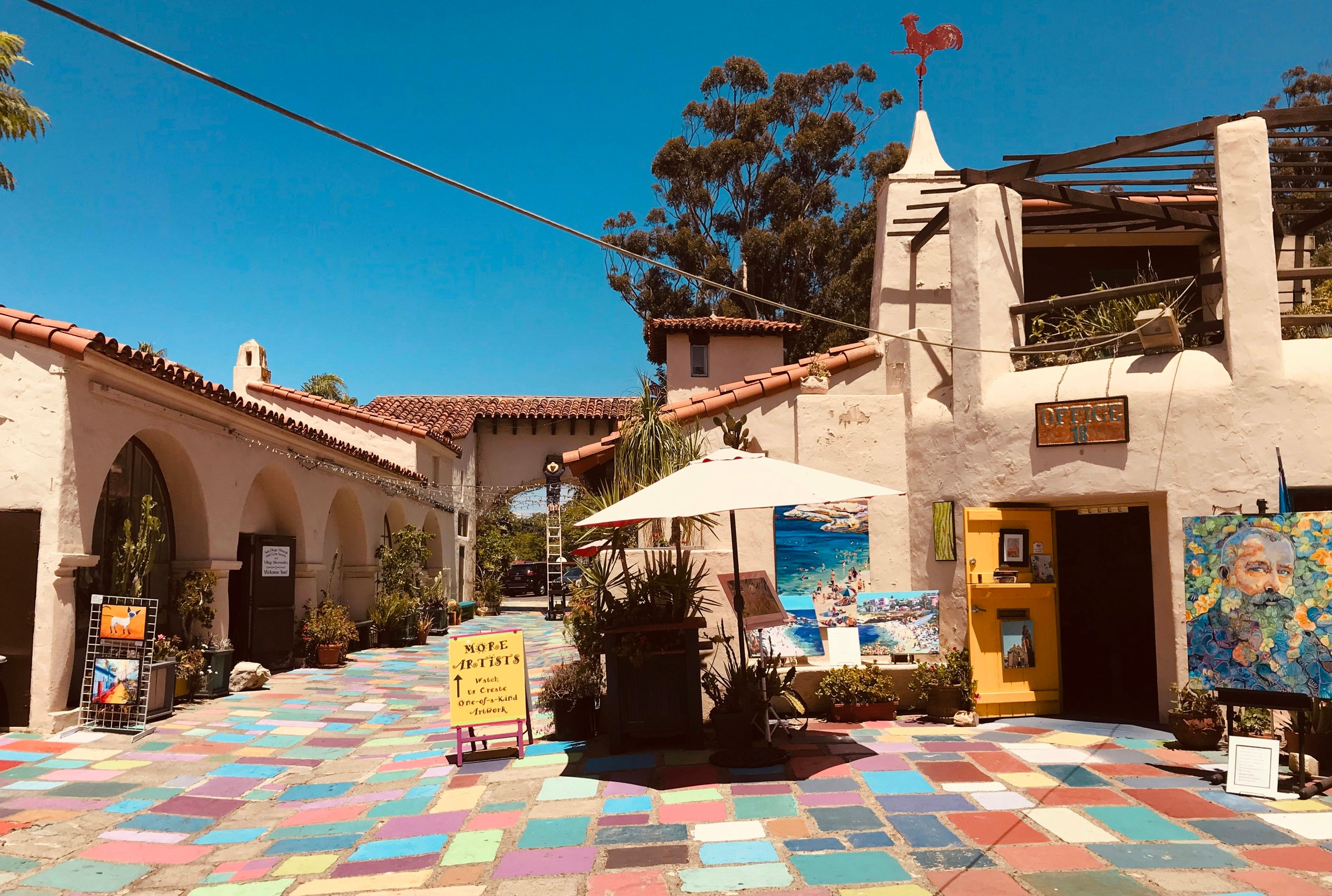Adobe buildings and courtyard at Old Town San Diego State Historic Park on a clear afternoon
