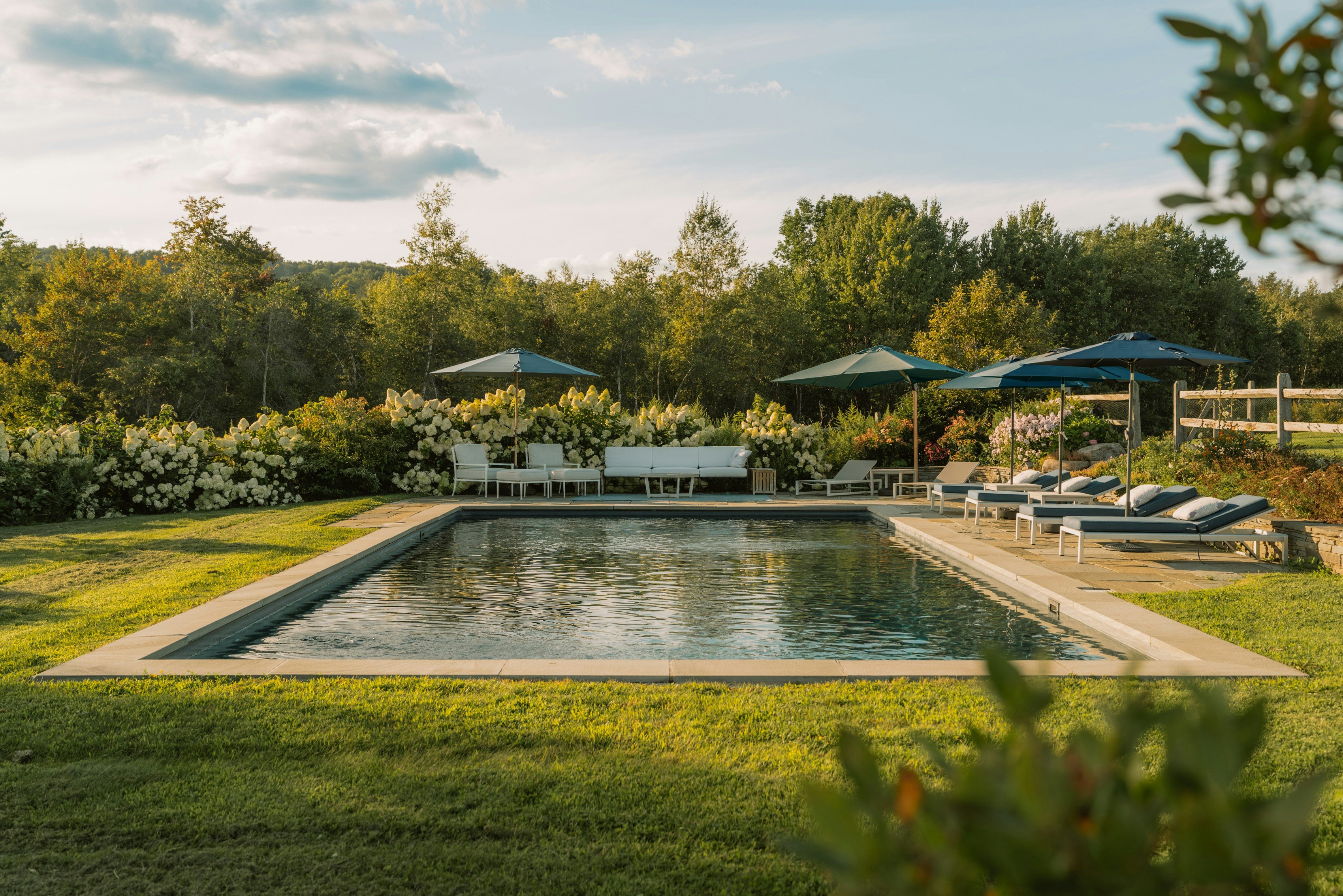Serene outdoor pool with lounge chairs and lush greenery