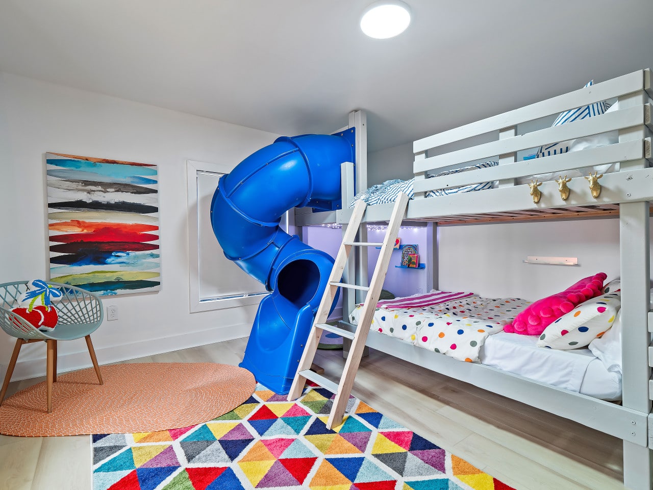 Kids bunk bedroom with built-in slide in a family-friendly short-term rental