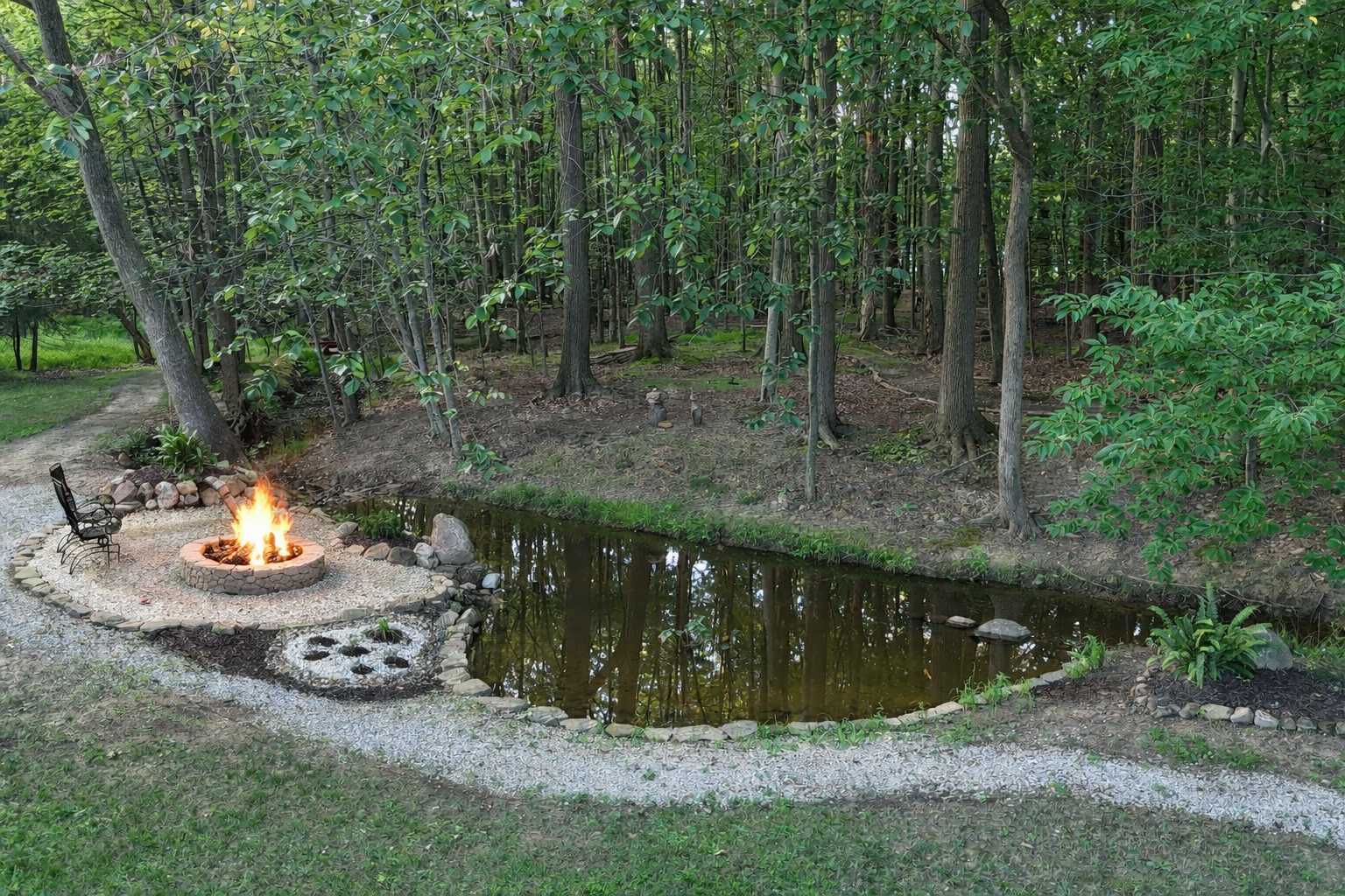 Secluded short-term rental backyard with firepit by water and outdoor seating