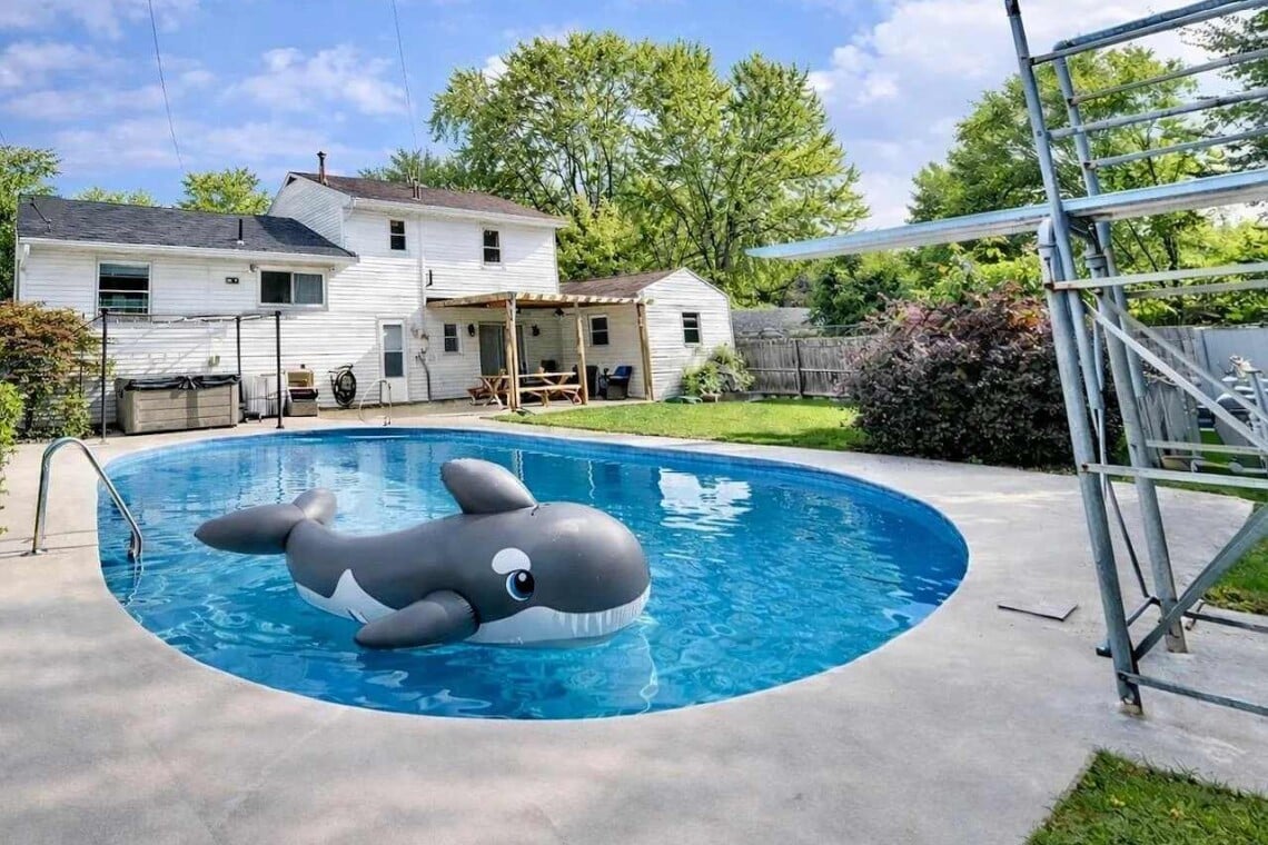 family friendly backyard pool with diving board and Shamu float at Ohio vacation rental