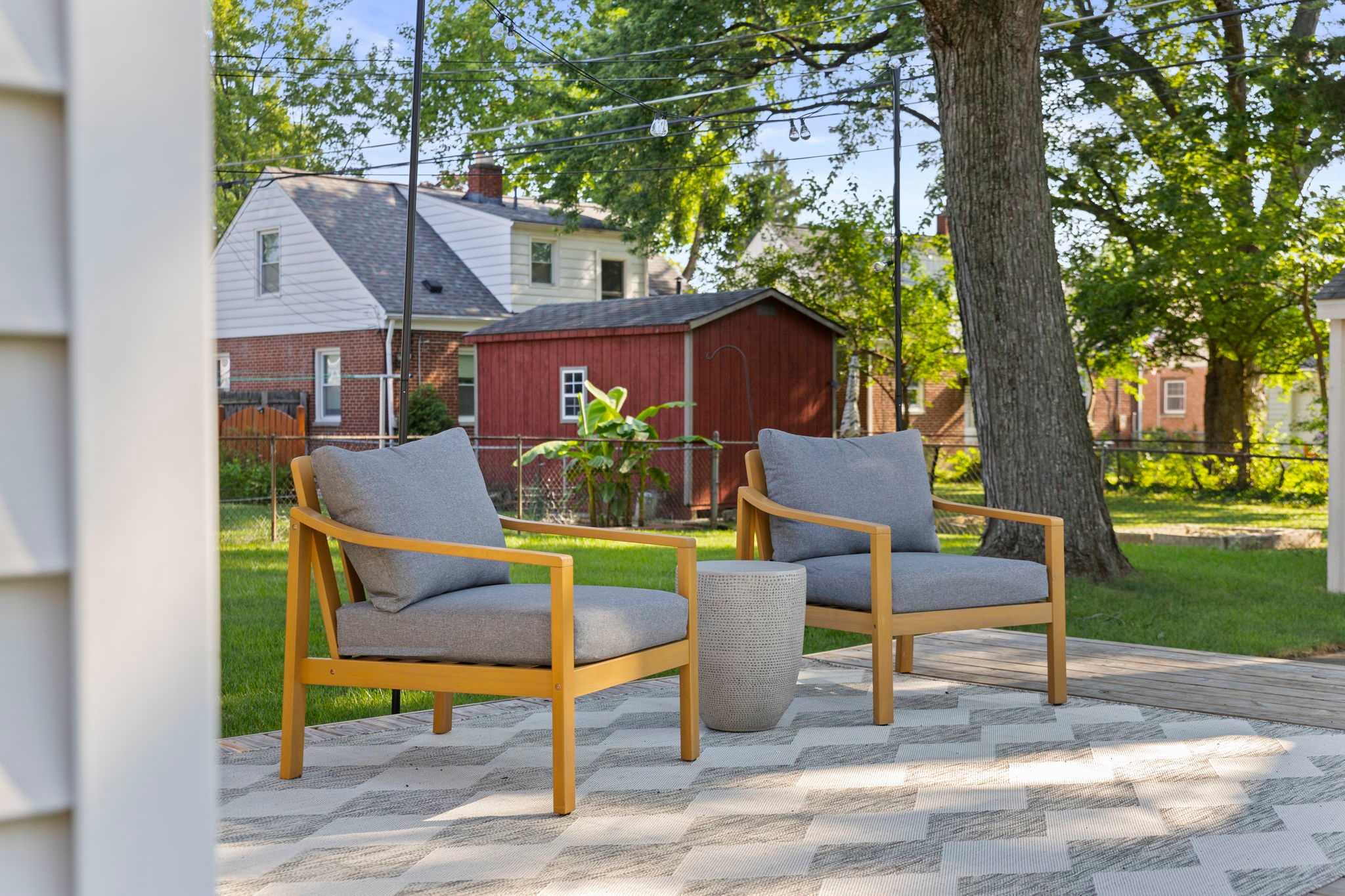 Beautiful outdoor sitting area at a short-term rental surrounded by trees and plants