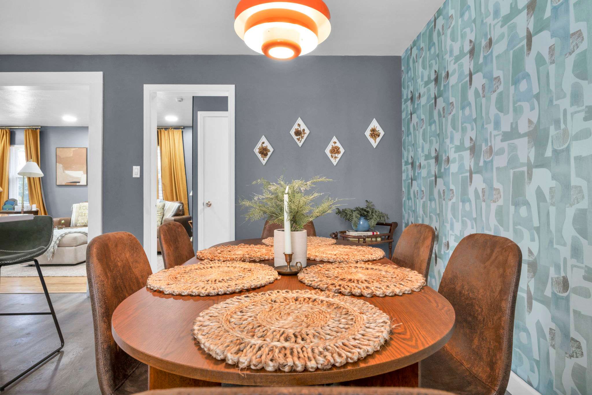 Beautiful vacation rental kitchen with stylish accent wall, modern finishes, and warm designer lighting