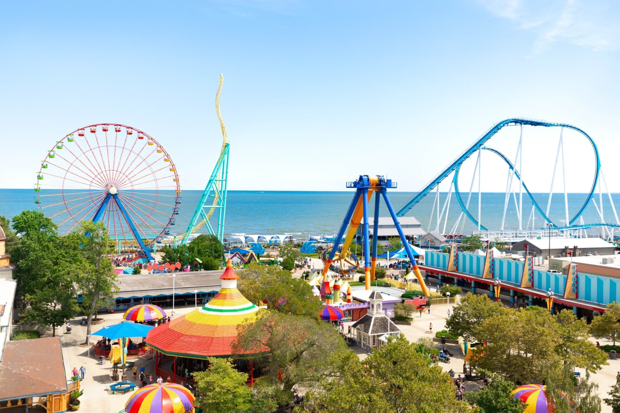 Cedar Point amusement park overlooking Lake Erie with roller coasters, ferris wheel, and summer crowds in Sandusky, Ohio