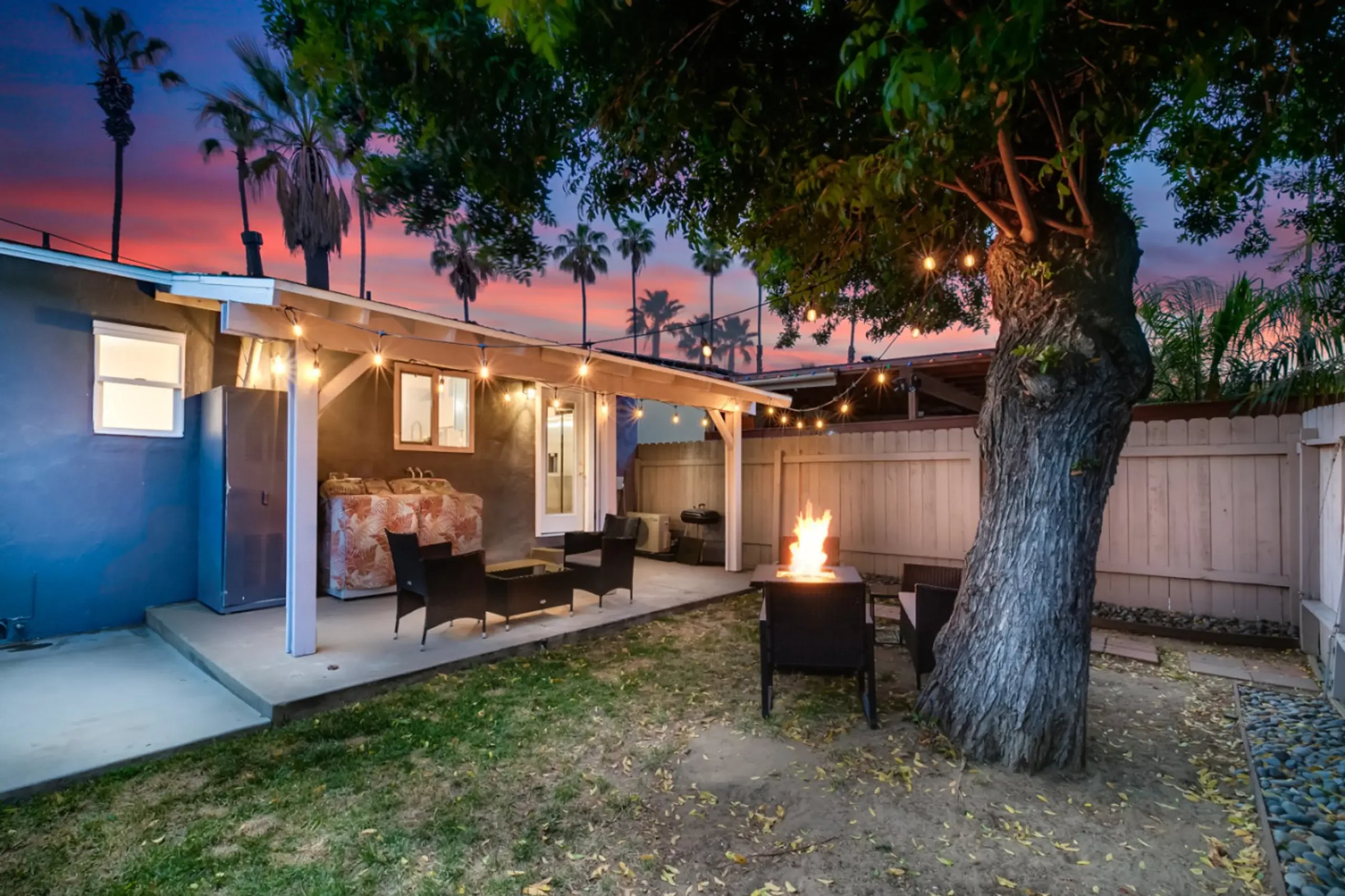 Modern patio with fire pit and string lights for San Diego property listing optimization