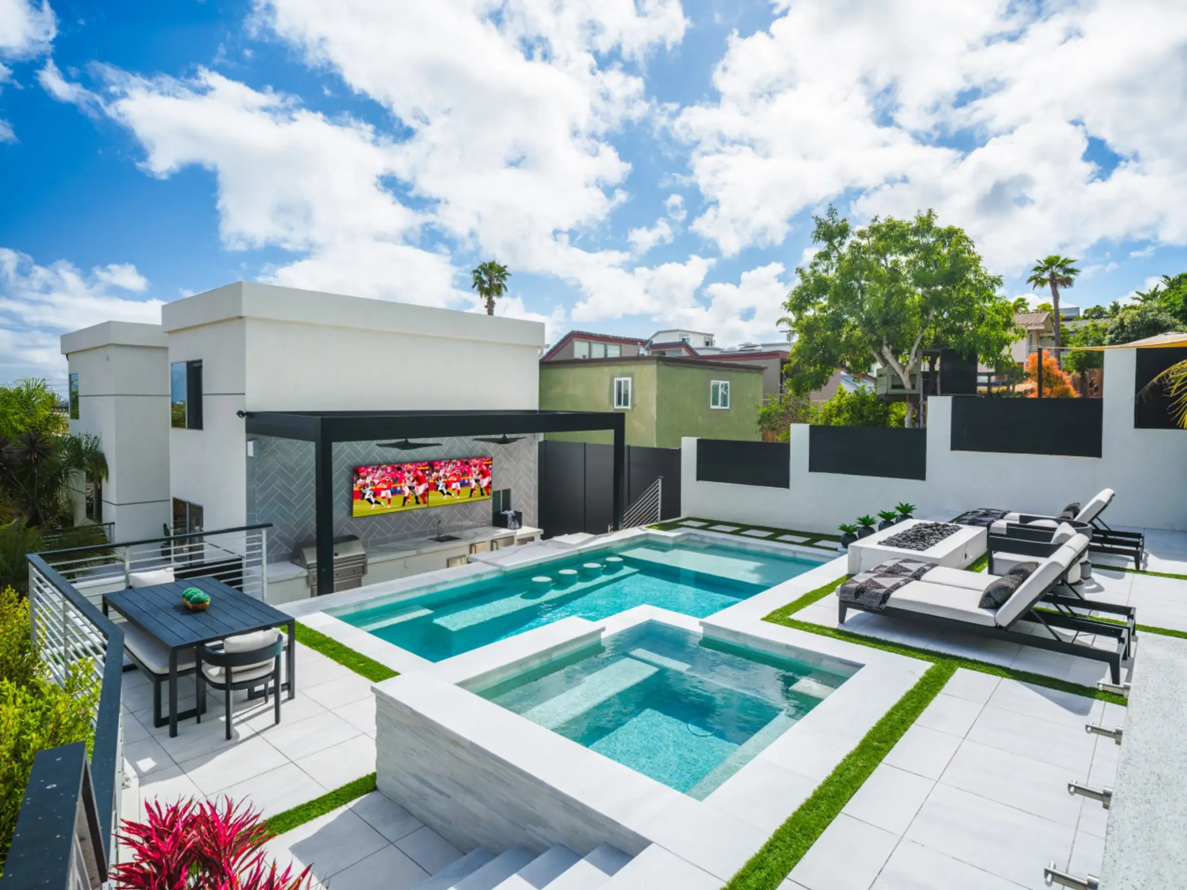 Luxury backyard with dual pools and spa representing premium amenities that impact vacation rental dynamic pricing analysis