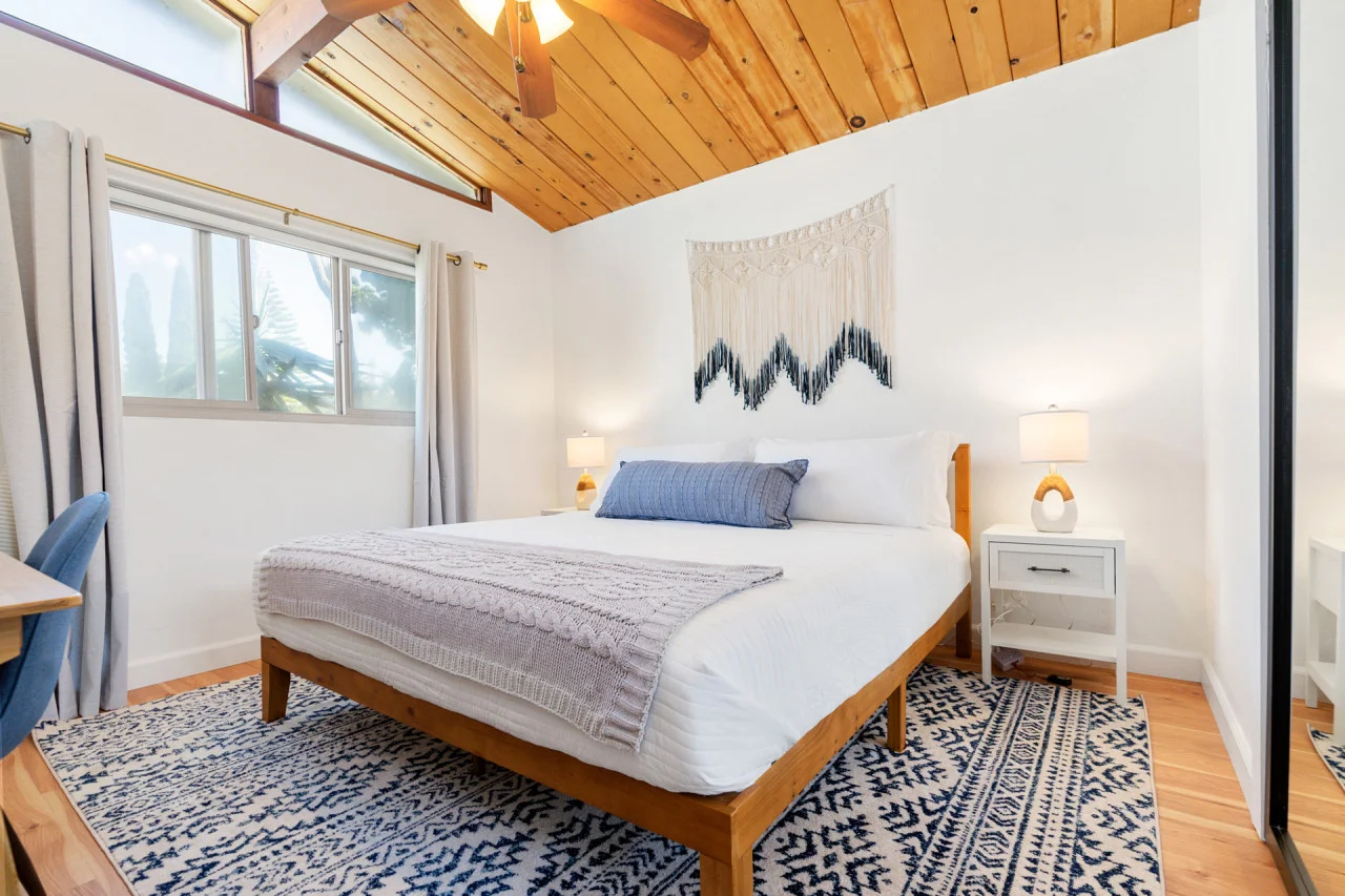 Professional vacation rental bedroom with white linens and modern decor in San Diego