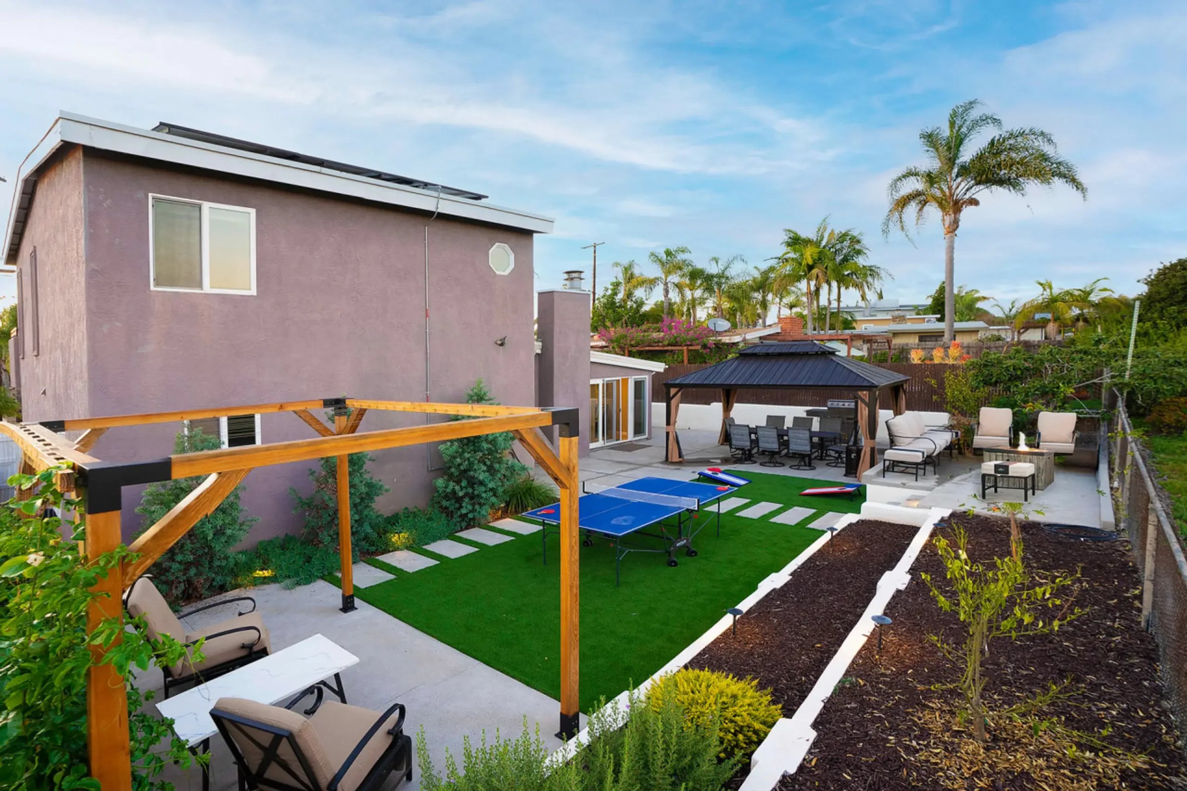 Modern backyard entertainment area with pergola and gazebo in San Diego real estate management property