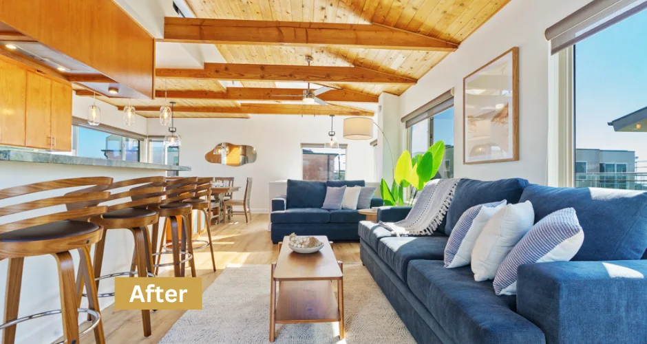 Modern open-concept living room with exposed beams and sectional sofa in San Diego rental property