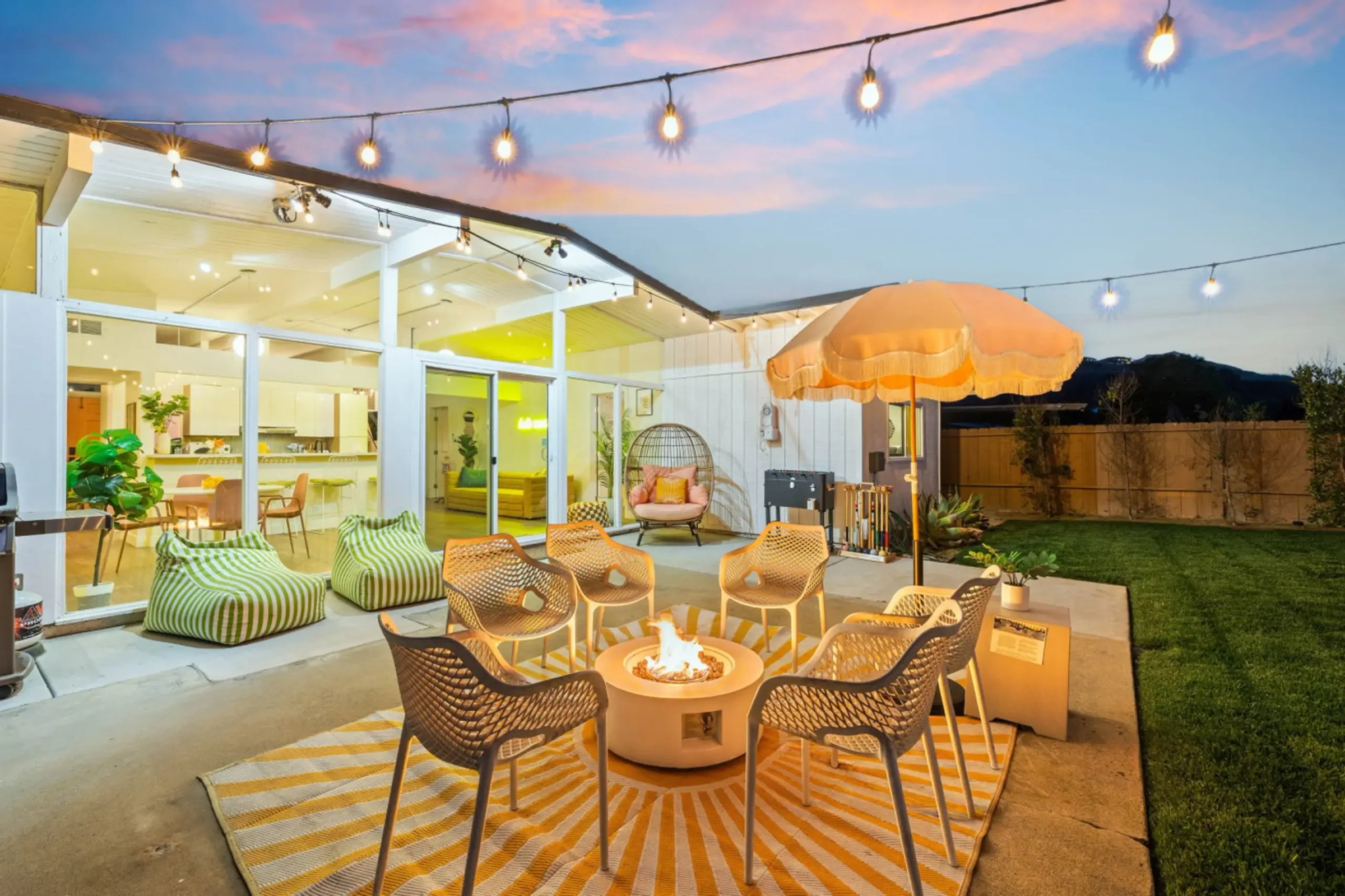 Modern patio with fire pit and string lights for Airbnb management company San Diego revenue dashboard