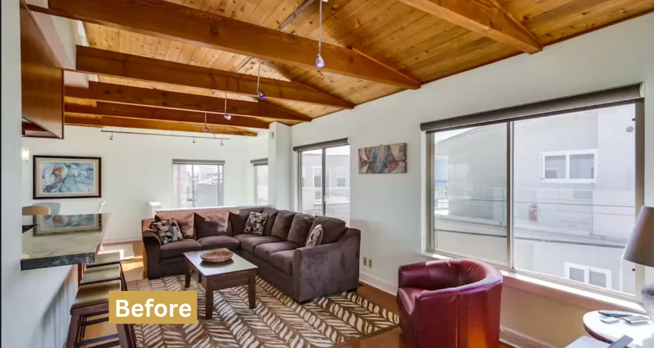 Modern San Diego living room with exposed beams and sectional sofa, representing quality short-term rental property