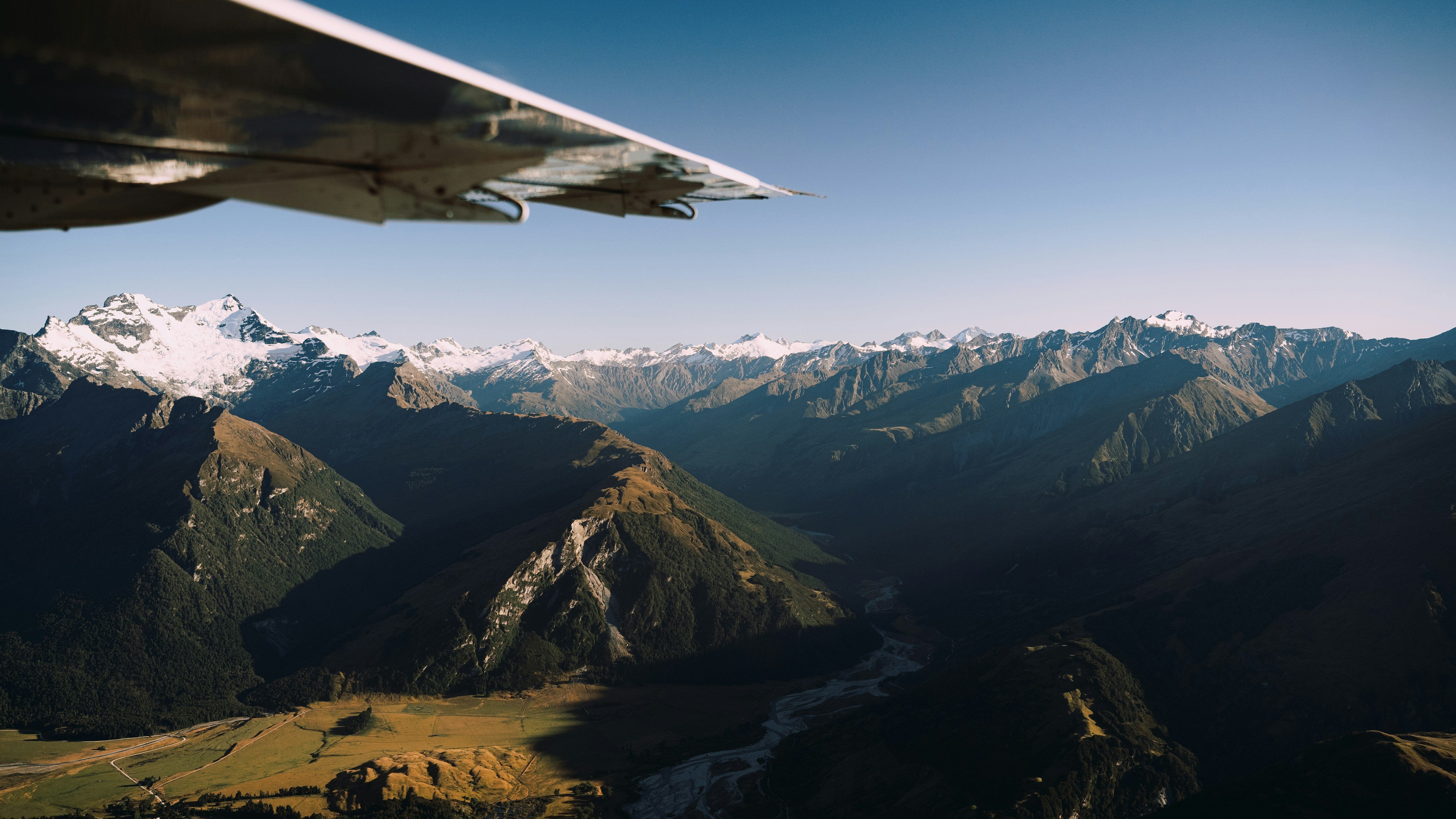 Snowy mountains seen from a plane window