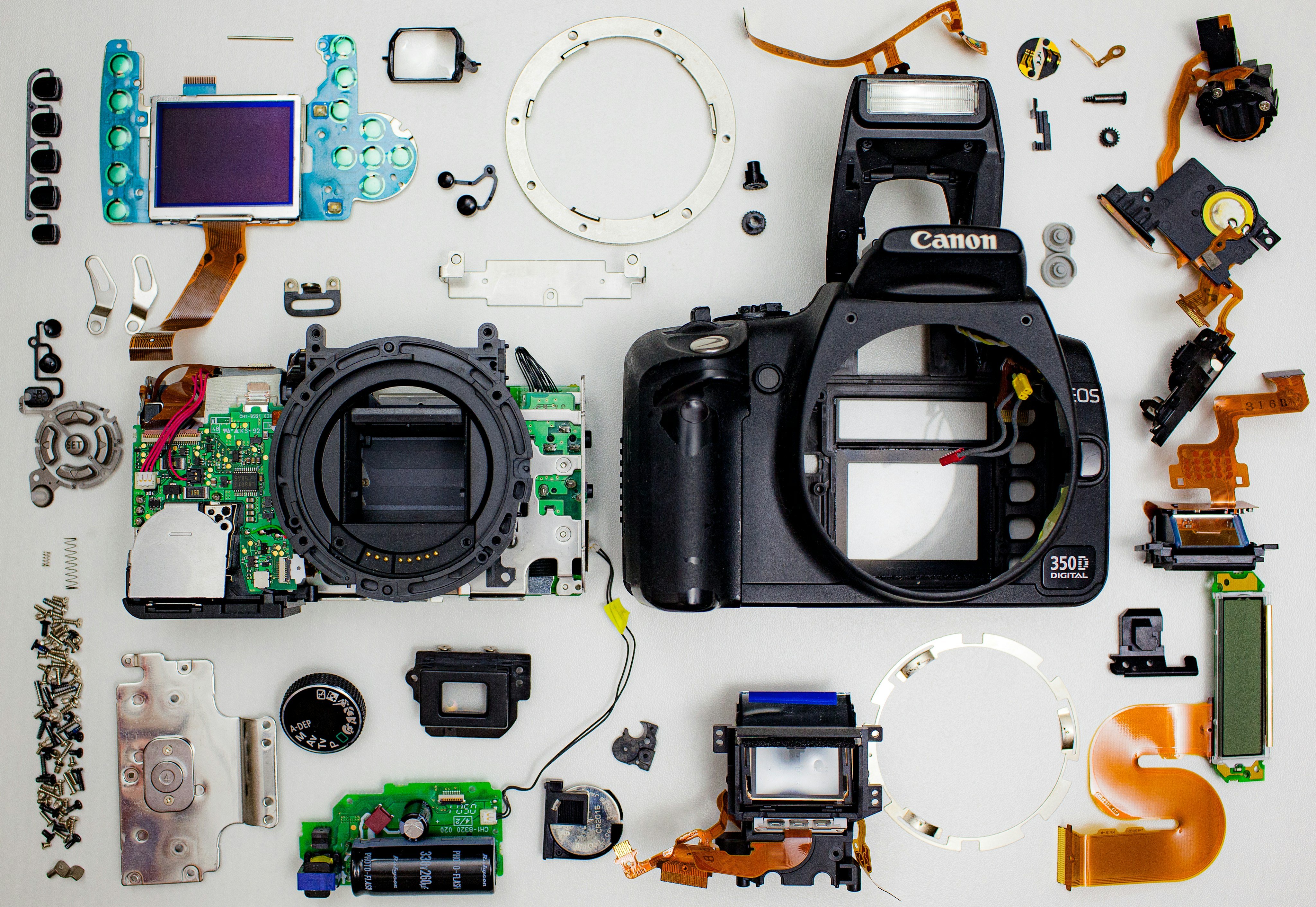 Camera parts laid out on a white surface