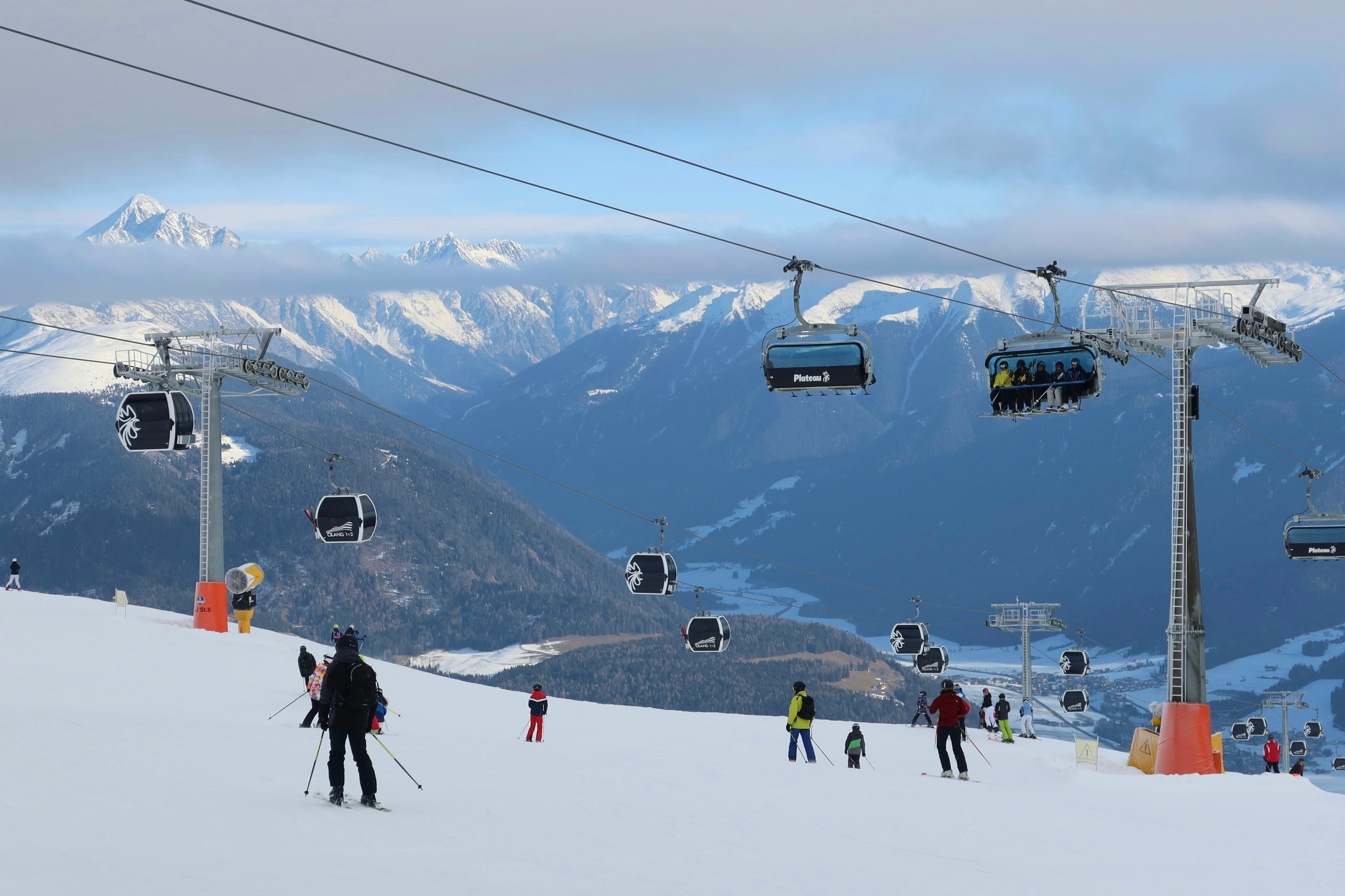 Skiers riding down a snowy slope