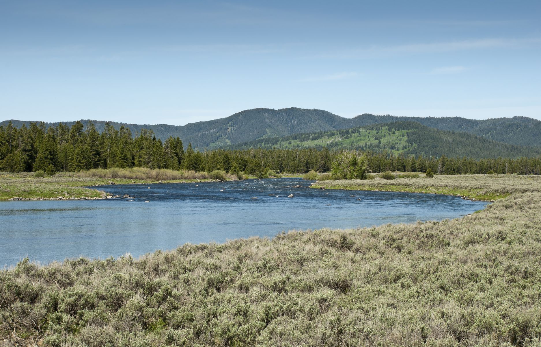River flowing with mountains in the background.