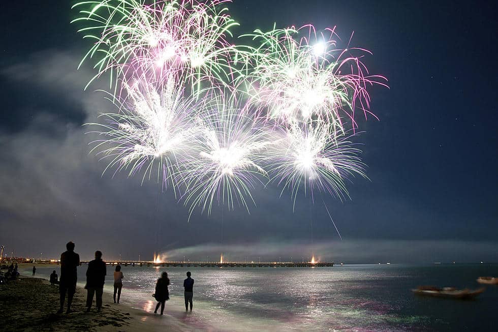 Fireworks display over the beach at Seaside Heights, with silhouetted spectators enjoying the summer concert atmosphere.