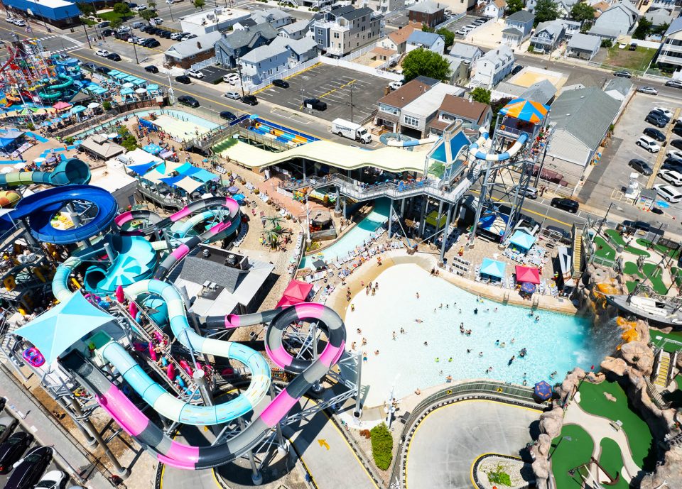 Aerial view of Breakwater Beach waterpark in Seaside Heights, featuring colorful water slides, a wave pool, and families enjoying the attractions on a sunny day.