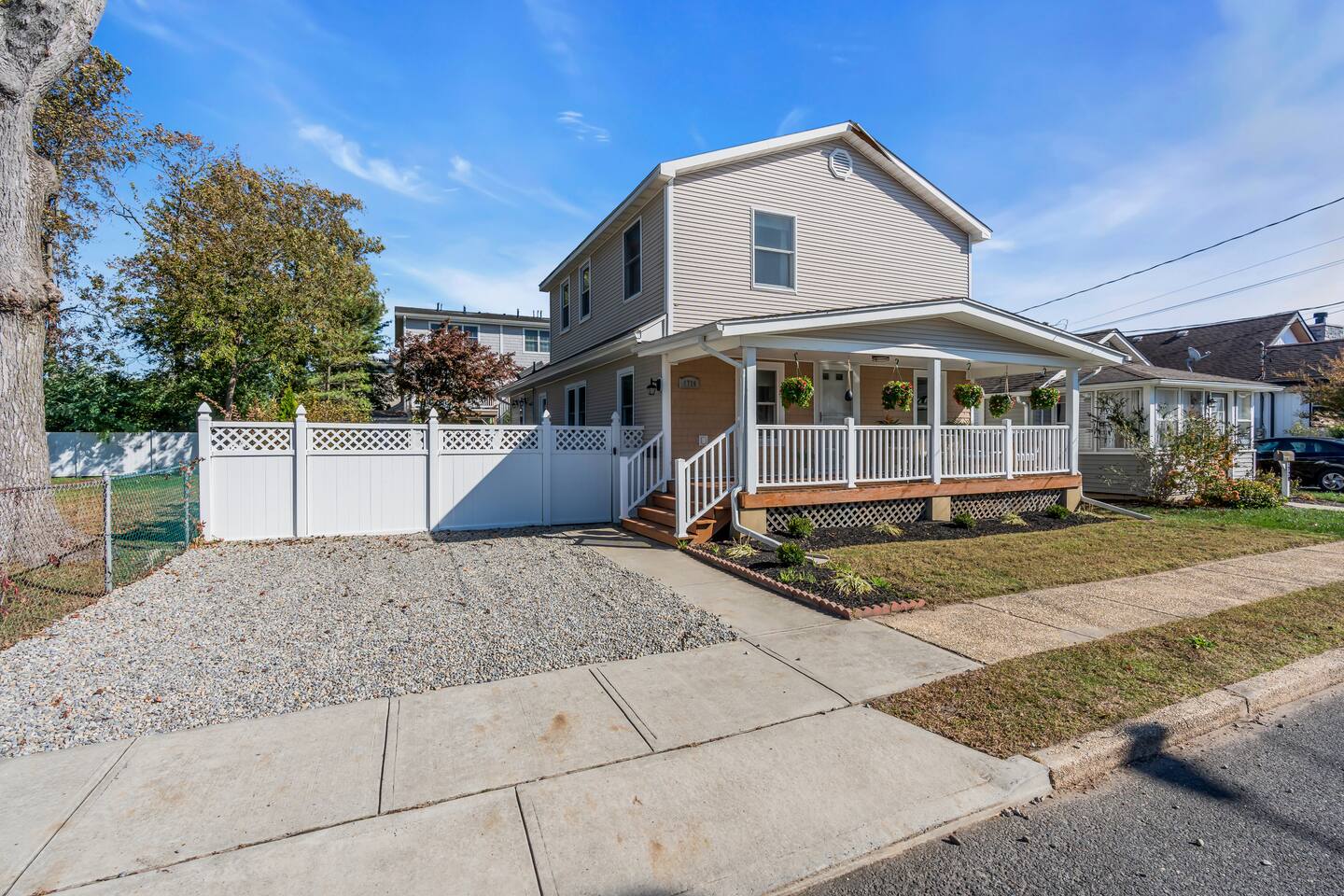 Single-family home at 1726 Belmont Ave in Belmar/Lake Como, NJ, featuring a welcoming porch, landscaped yard, and fenced area, representing a cash-flowing short-term rental opportunity.