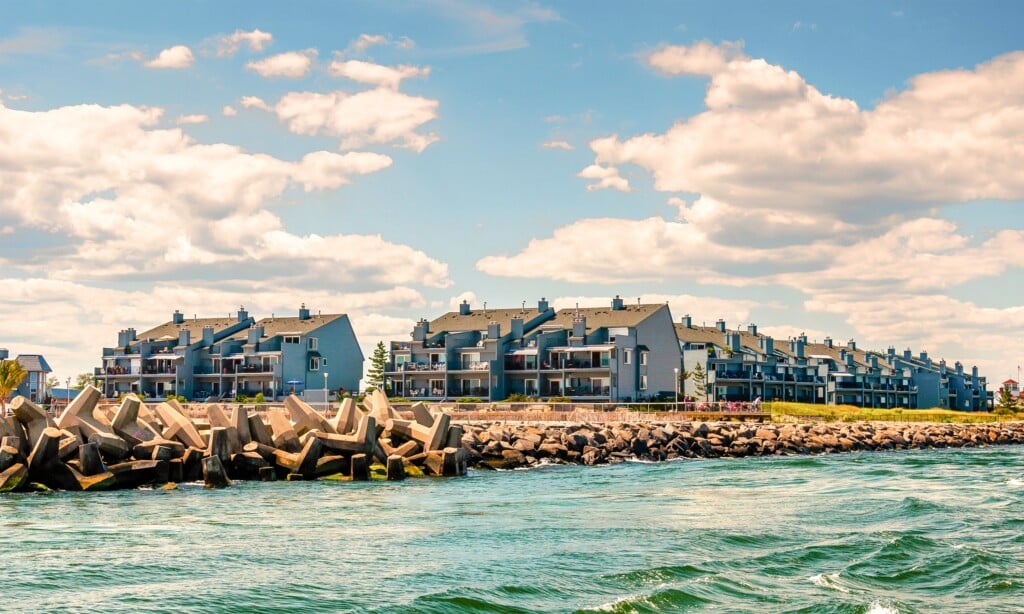 Coastal residential buildings along the shoreline in Point Pleasant, featuring modern architecture and a scenic waterfront view, highlighting the community's year-round appeal and beachside lifestyle.