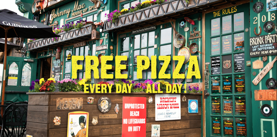 Johnny Mac's House of Spirits bar exterior featuring colorful signage, vibrant flowers, and a promotion for free pizza, highlighting a lively, dog-friendly atmosphere in Asbury Park.