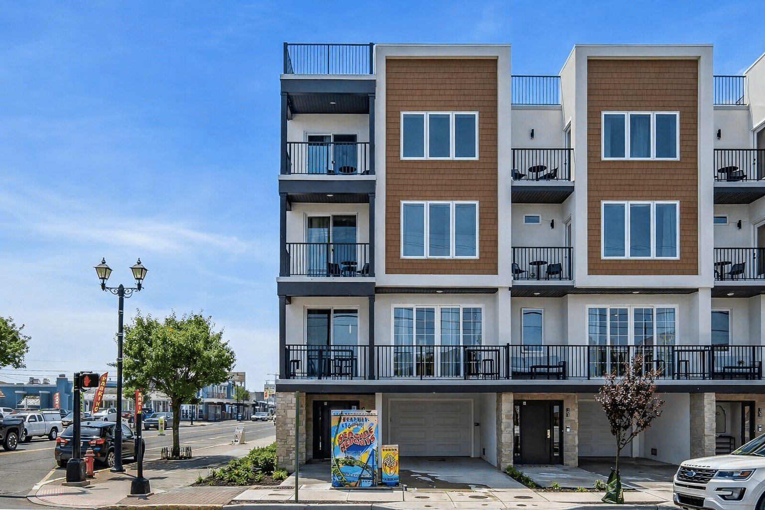 New construction condo building at 101–107 Grant Ave, Seaside Heights, featuring rooftop balconies, ocean views, and a corner-lot location, designed for short-term rentals.