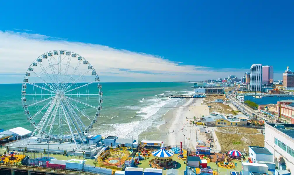 Atlantic City boardwalk view and observation wheel overlooking the ocean and beach.